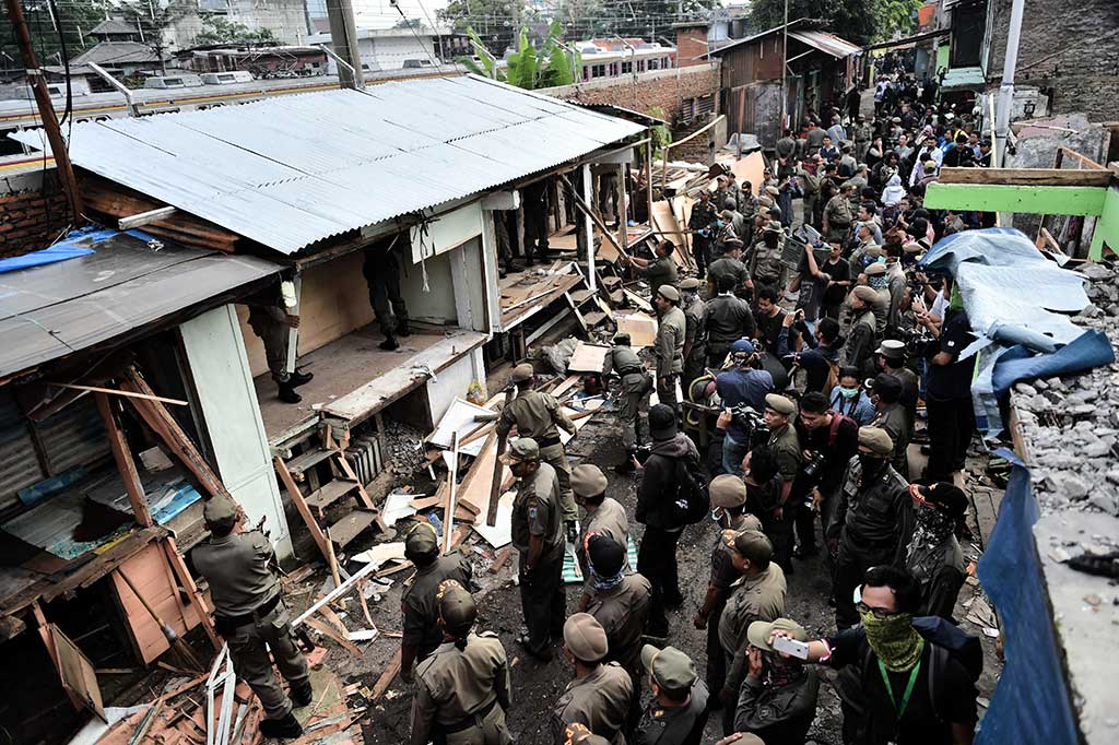 Ratusan personel Satuan Polisi Pamong Praja (Satpol PP) membantu membersihkan kawasan tersebut.