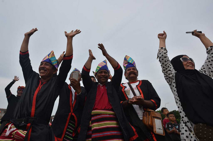 Peserta meluapkan kegembiraan setelah berhasil menerbangkan layang-layang berbahan daun Kolope dalam pemecahan rekor dunia.
