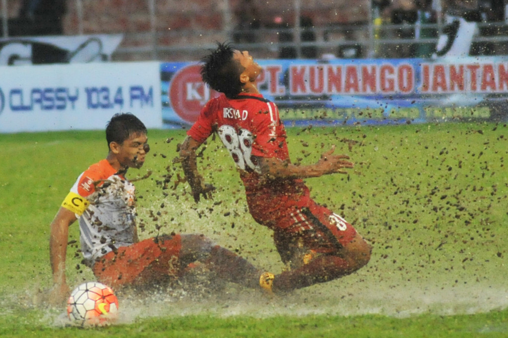 Pesepakbola Semen Padang FC, Irsyad Maulana (kanan) dijegal pemain Perseru Serui, Bilibig Dian Mahrus (kiri), pada pertandingan lanjutan Torabika Soccer Championship (TSC) 2016 di Stadion GOR H Agus Salim, Padang, Rabu (12/10/2016).