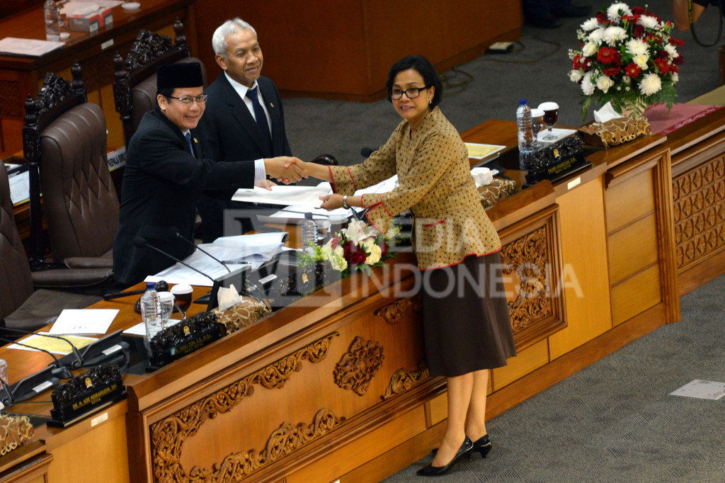 Menteri Keuangan Sri Mulyani (kanan) menyerahkan pandangan pemerintah kepada Wakil Ketua DPR Taufik Kurniawan (kiri) disaksikan Wakil Ketua DPR Agus Hermanto dalam Sidang Paripurna DPR di Kompleks Parlemen Senayan, Jakarta, Rabu (26/10/2016)