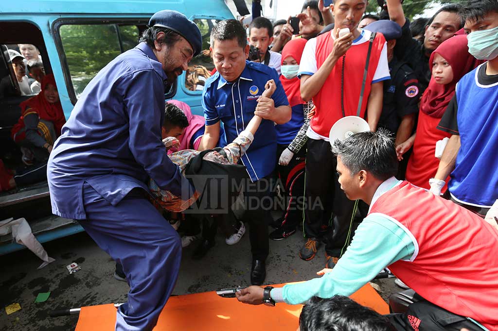 Ketua Umum Partai NasDem Surya Paloh dan Ketua DPW Partai NasDem Sulsel Rusdi Masse, membantu evakuasi korban kecelakaan di jalan raya saat simulasi penanganan kecelakaan di depan Kampus II Badan Diklat Provinsi Sulsel, Makassar.