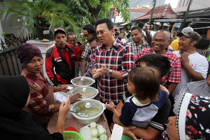 Ahok berbincang dengan warga saat blusukan di kawasan Serdang, Kemayoran, Jakarta.