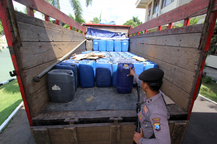 Sejumlah anggota kepolisian memeriksa barang bukti minuman keras (miras) jenis arak di Mapolres Banyuwangi, Jawa Timur, Kamis (3/11/2016)