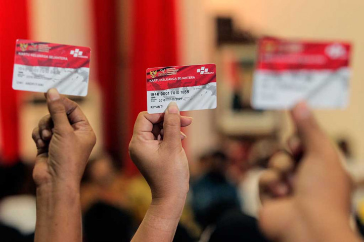 Warga menunjukkan kartu PHK pada acara peluncuran Penyaluran Bantuan Sosial Non Tunai PKH 2016.