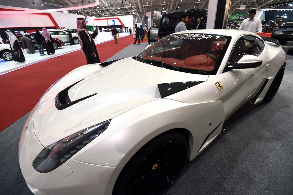 Seorang pengunjung memotret sebuah Ferrari. Seratusan unit kendaraan roda empat dan dua model terbaru, tercanggih dan termewah ditampilkan. Termasuk produk asesoris pendukungnya. AFP PHOTO / FAYEZ NURELDINE