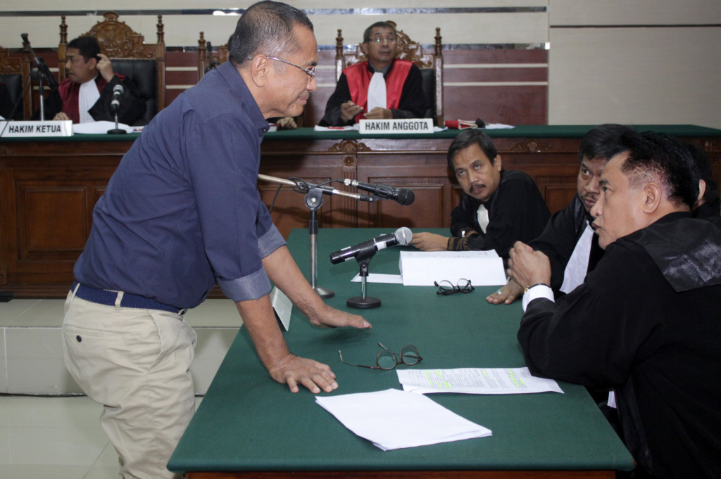 Terdakwa kasus dugaan korupsi pelepasan aset PT PWU Jatim, Dahlan Iskan (kiri) berdiskusi dengan penasihat hukumnya Yusril Ihza Mahendra (kanan) saat sidang lanjutan di Pengadilan Tindak Pidana Korupsi (Tipikor) Surabaya, Jawa Timur.