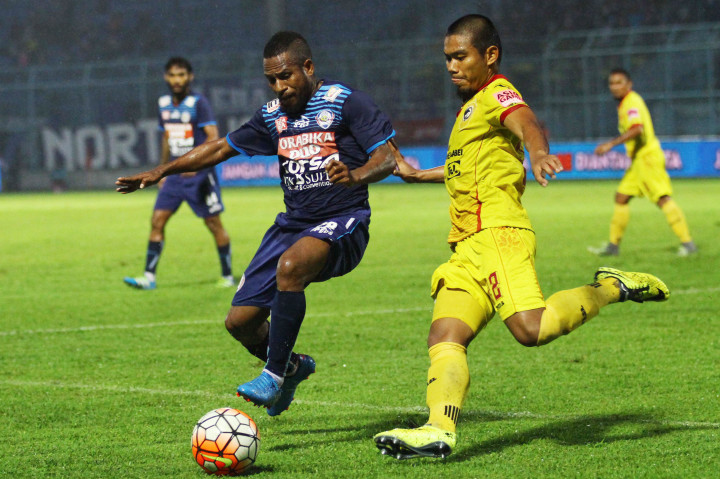 Pesepakbola Arema Cronus, Okto Maniani (kiri), berusaha mempertahan bola dari pesepakbola Sriwijaya FC, Wildansyah.