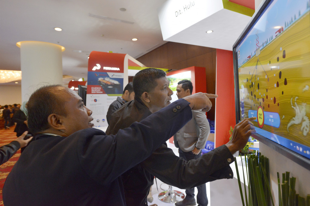 Pengunjung mencoba sebuah permainan dalam pameran yang diselenggarakan di sela-sela Pertamina Energy Forum 2016.