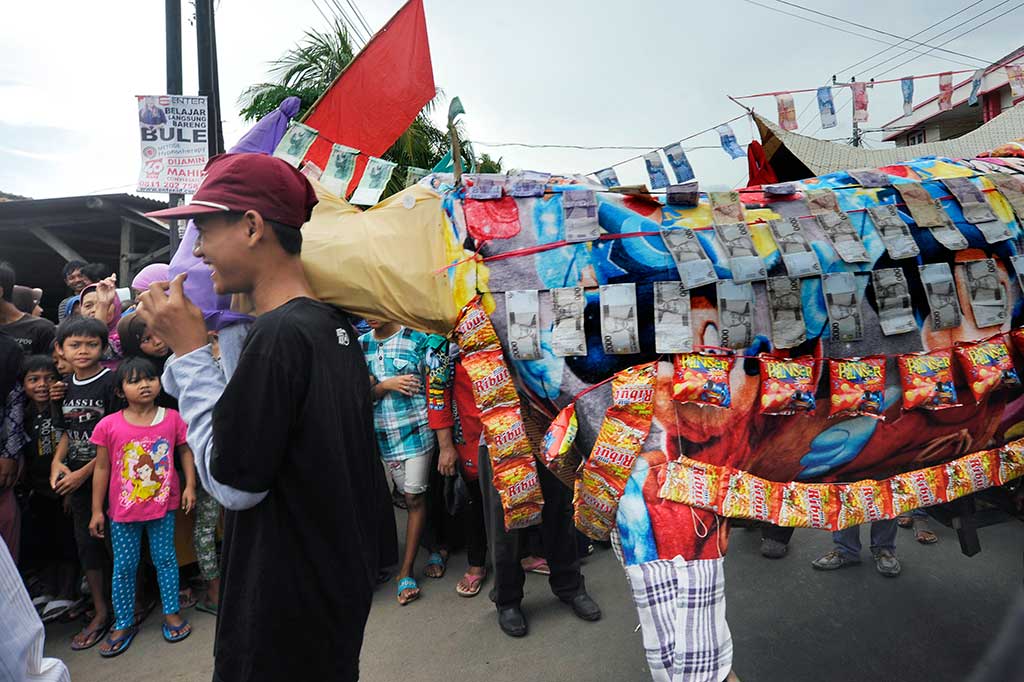 Anak-anak menyaksikan pawai pernak-pernik 'Panjang' di Pejaten, Serang, Banten.