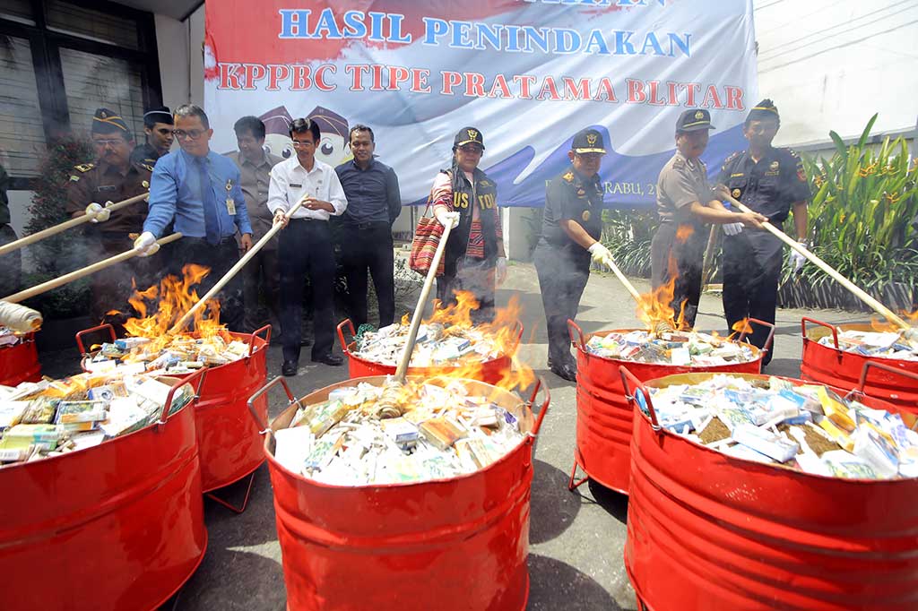 Anggota Komisi XI DPR Eva Kusuma Sundari (tengah) didampingi Kepala Kanwil Bea dan Cukai Jatim II Nirwala (ketiga kanan) memusnahkan jutaan batang rokok ilegal, di Kantor Bea dan Cukai Blitar.