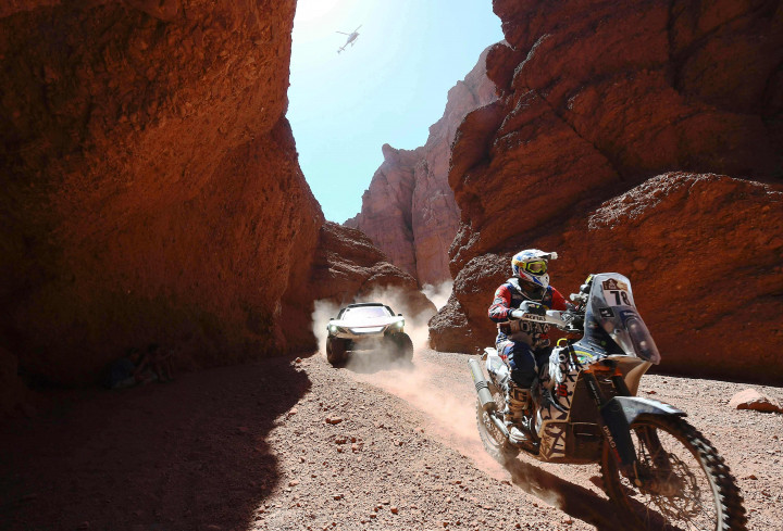 Ibraheem Alrubaian memacu KTM tunggangannya diikuti Peugeot yang dipacu Carlos Sainz - Lucas Cruz di celah pegunungan cadas etape 3 di Argentina. 