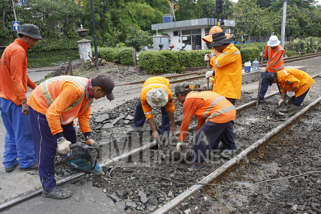 Sejumlah pekerja dari PT KAI tengah memperbaiki perlintasan rel kereta api yang rusak di dekat Stasiun Manggarai, Jakarta.