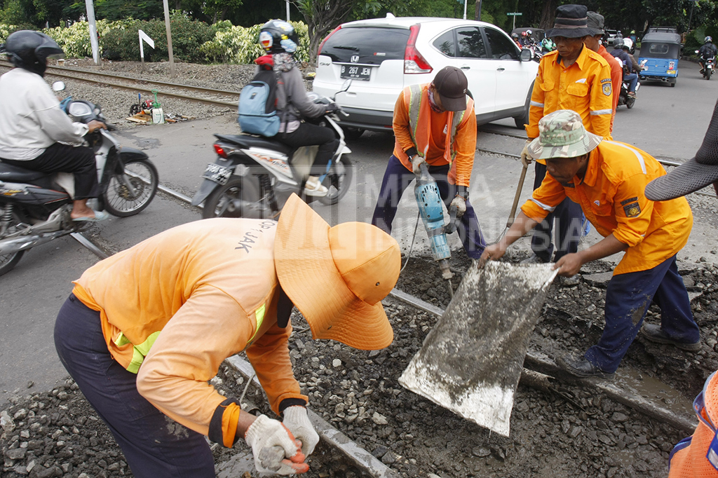 Sejumlah pekerja dari PT KAI tengah memperbaiki perlintasan rel kereta api yang rusak di dekat Stasiun Manggarai, Jakarta.