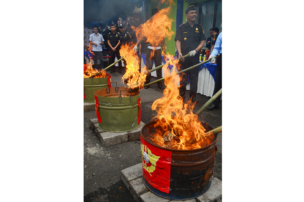 Kepala Kantor Bea Cukai Pratama Tasikmalaya, Heri Purwadi (kanan) memusnahkan barang bukti hasil sitaan di Halaman Kantor Pengawasan dan Pelayanan Bea dan Cukai Tipe Pratama Tasikmalaya, Jawa Barat, Rabu (18/1/2017).