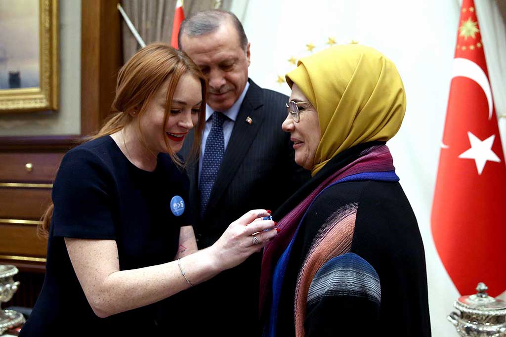 Lohan menyematkan lencana biru untuk Erdogan dan istrinya, dengan kutipan terkenal Erdogan 'Dunia Lebih Besar dari Lima'.