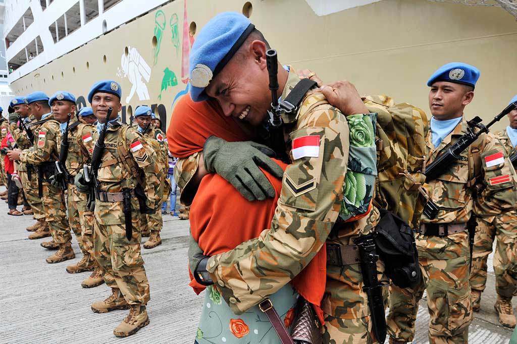 Seorang personel TNI Yonzipur VIII/SMG Kodam VII Wirabuana anggota Pasukan Garuda disambut keluarganya saat tiba di Dermaga Sukarno, Makassar.