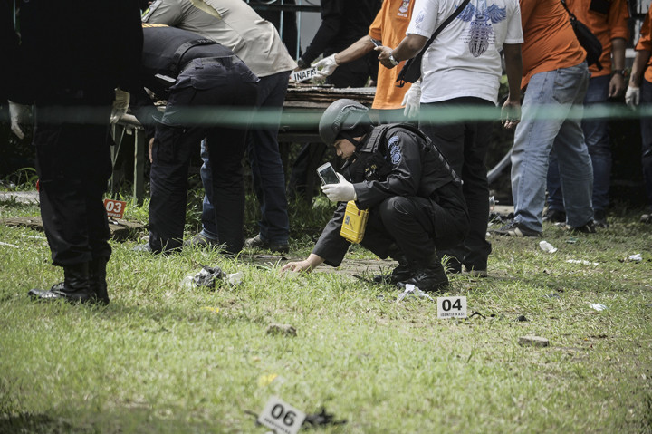 Para petugas memeriksa serpihan bom yang masih terlihat di tempat pengeboman berupa sisa bahan alumunium sejenis panci dan serbuk berwarna putih juga paku-paku yang bertebaran di sekitar TKP.