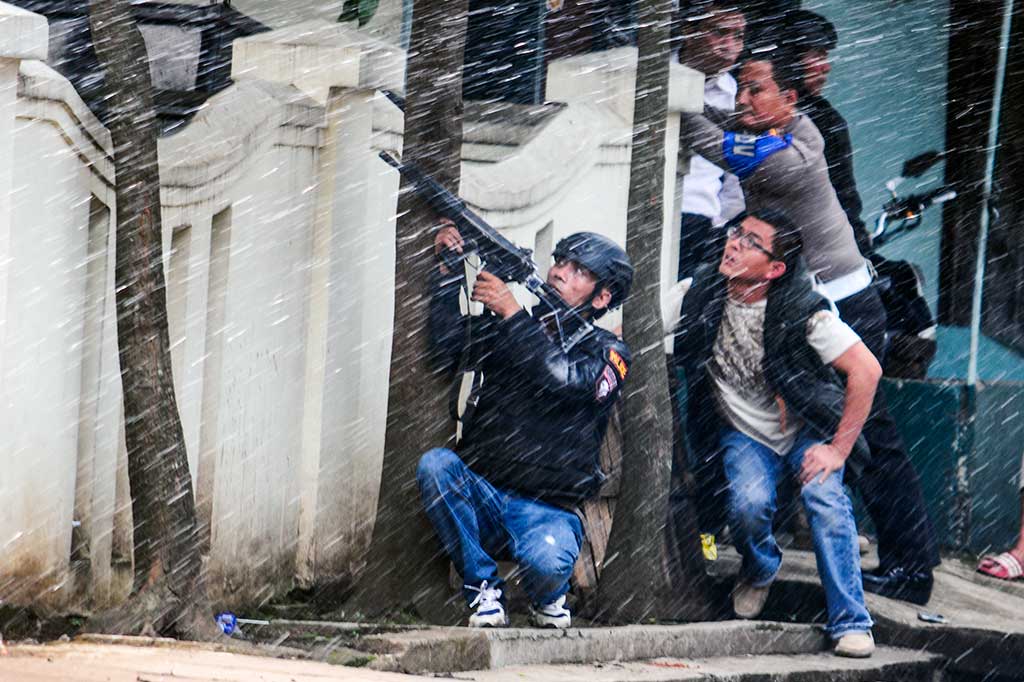 Petugas kepolisian bersenjata lengkap berusaha melumpuhkan terduga teroris di Kantor Kelurahan Arjuna. ANTARA/Novrian Arbi