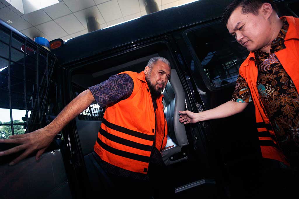 Mantan hakim konstitusi Patrialis Akbar (kiri) bersama pengusaha Andi Agustinus atau Andi Narogong keluar dari mobil tahanan yang sama saat tiba di Gedung Merah Putih, KPK, Jakarta, Selasa (4/4/2017).