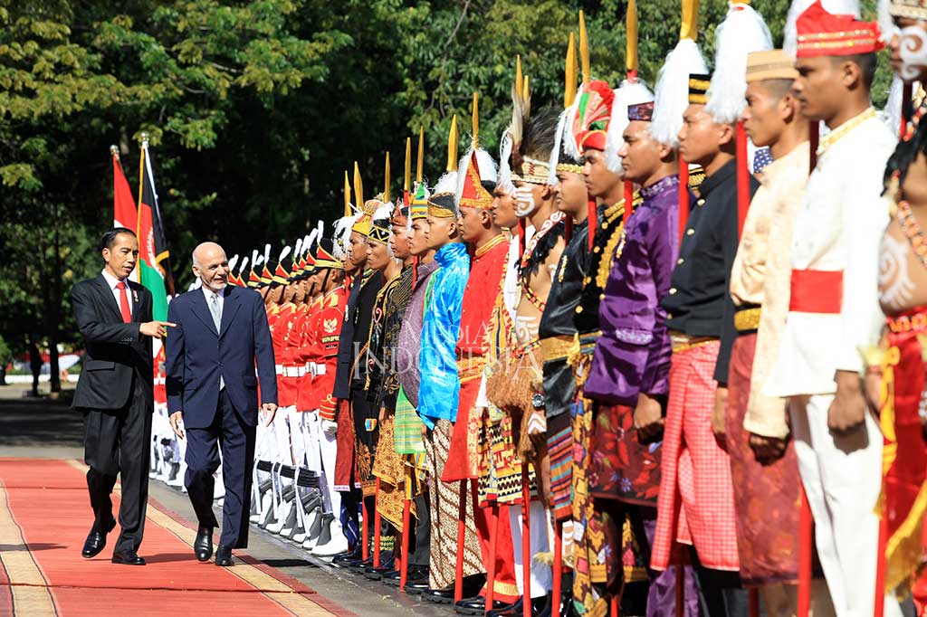 Presiden Jokowi menjelaskan pakaian adat daerah yang dikenakan pasukan pengamanan presiden kepada Presiden Afghanistan Mohammad Ashraf Ghani.