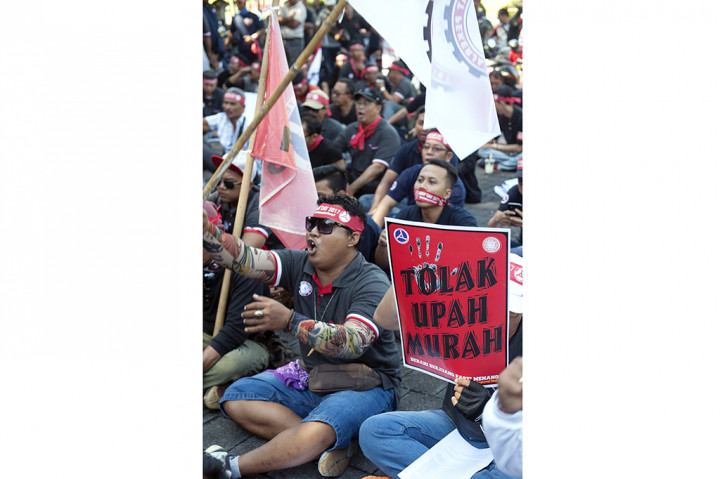 Ratusan pengunjuk rasa yang tergabung dalam Aliansi Buruh Bali Bersatu menggelar aksi unjuk rasa di depan kantor Gubernur Bali, Denpasar, Bali. ANTARA/Nyoman Budhiana