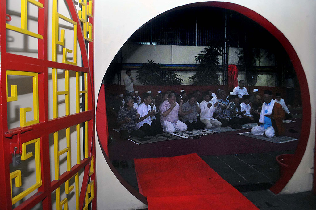Warga muslim memanjatkan doa seusai salat Magrib berjemaah saat buka puasa bersama di Wihara Dhanagun, Bogor. ANTARA/Arif Firmansyah