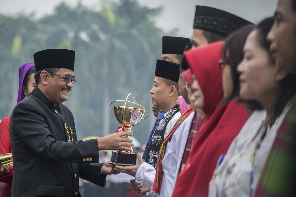 Gubernur DKI Jakarta Djarot Saiful Hidayat memberikan penghargaan kepada sejumlah pegawai Pemprov DKI Jakarta ketika upacara peringatan HUT DKI Jakarta ke-490 di Monas, Jakarta, Kamis (22/6/2017).