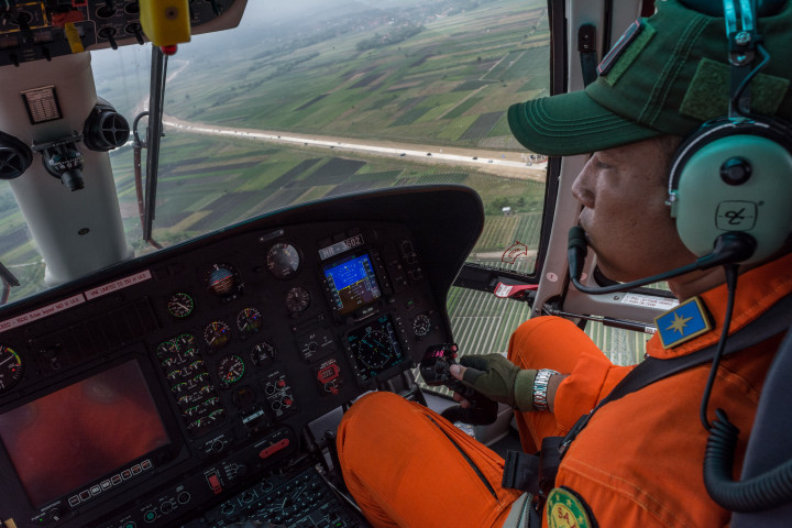 Kapten Pilot Sinaga menerbangkan helikopter Badan SAR Nasional memantau arus mudik di jalan tol darurat Brebes-Batang di Batang, Jawa Tengah, Jumat (23/6). Helikopter juga digunakan untuk evakuasi pemudik yang membutuhkan pertolongan medis cepat. ANTARA FOTO/Aji Styawan