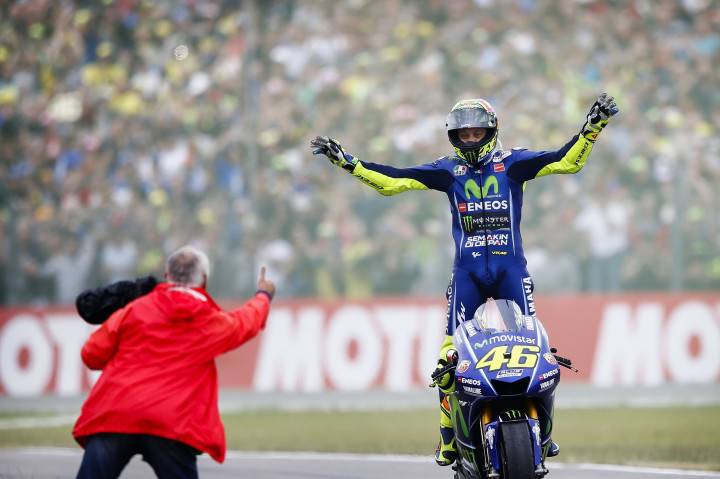 Victory lap khas Rossi. Penggemarnya termasuk fanatik dan tak segan menyebrang ke tengah sirkuit untuk menyalami Rossi. 
