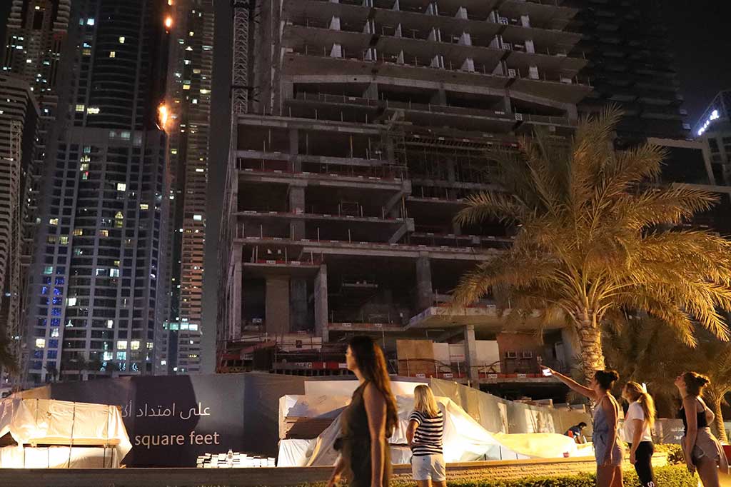 Api membakar sisi menara Torch, kebakaran kedua kalinya sejak kejadian 2015, yang memaksa ratusan penghuni menyelamatkan diri saat puing-puing kebakaran berjatuhan di kedua sisi bangunan 79 lantai tersebut.