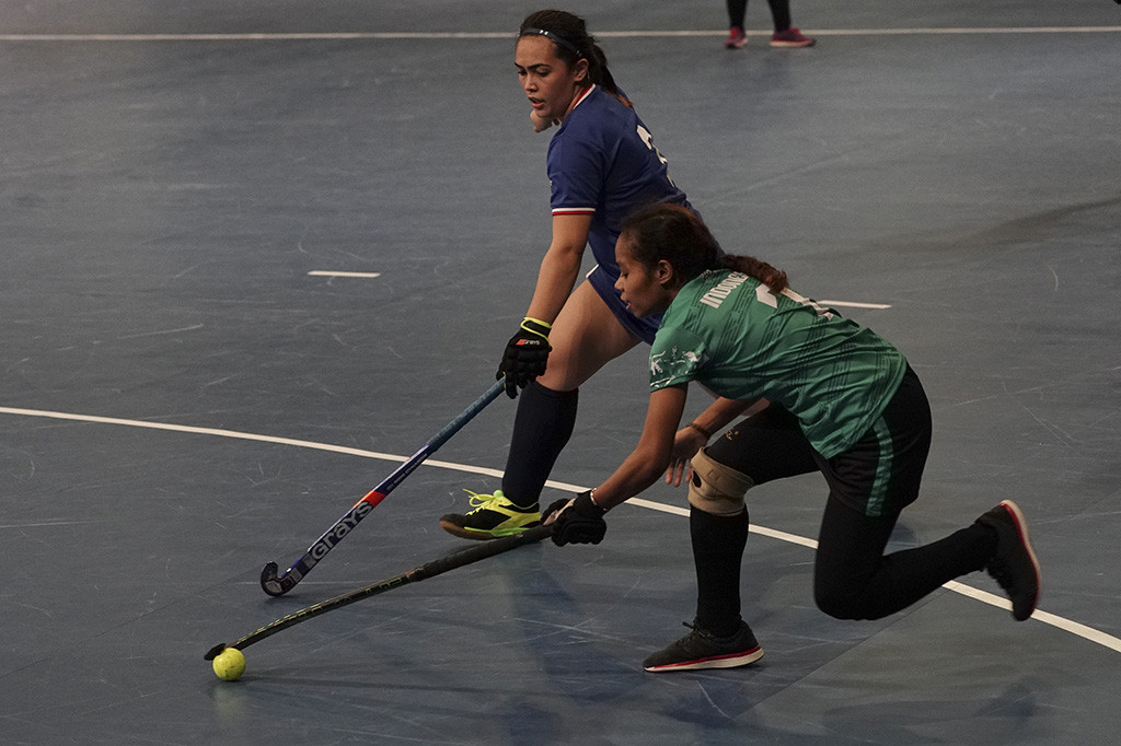 Atlet hoki indoor putri Indonesia Lina Rumaropen berebut bola dengan atlet hoki Filipina Paula Dumaplin pada pertandingan dengan format setengah kompetisi SEA Games 2017 Kuala Lumpur.
