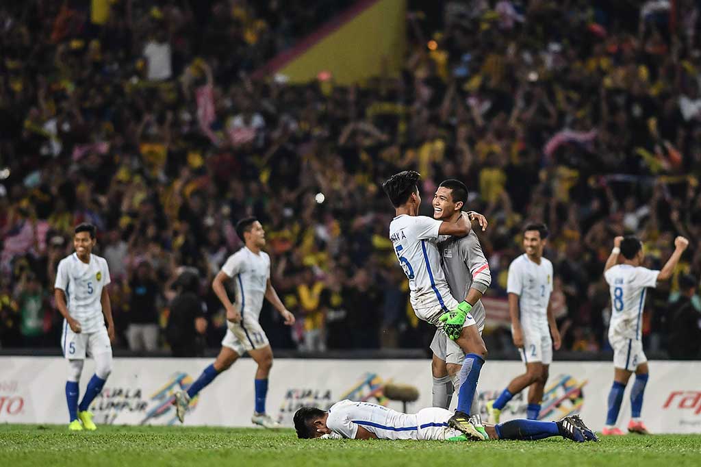 Para pemain Malaysia meluapkan kegembiraan mereka usai memastikan diri melaju ke final dan akan bertemu dengan Thailand. AFP/Mohd Rasfan