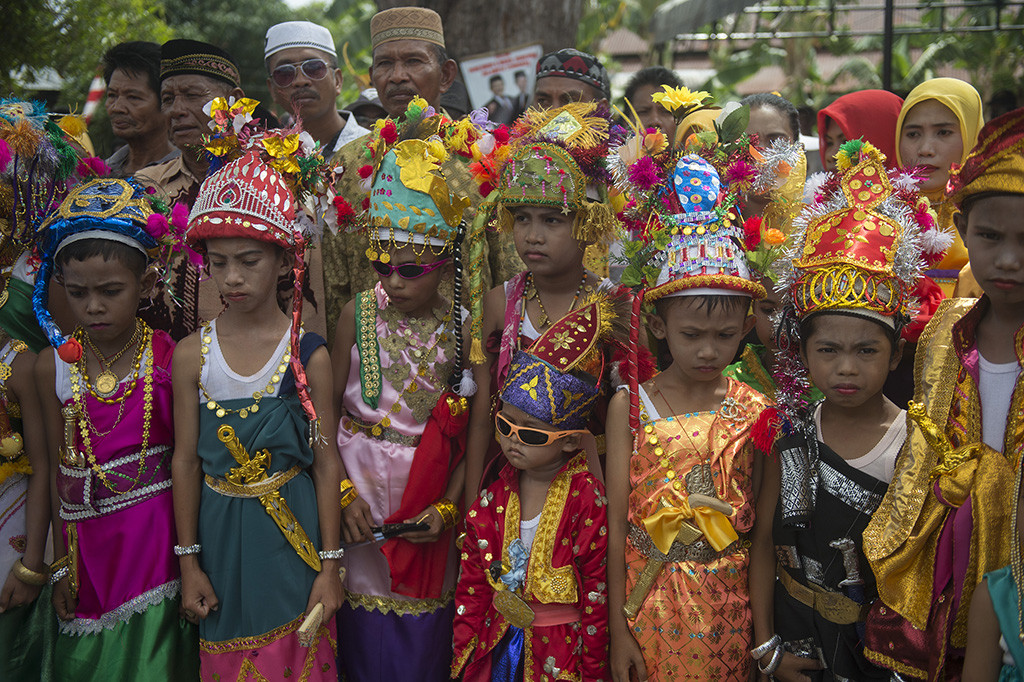 Anak laki-laki yang telah diberi kostum berbaris sebelum ritual Henauka Mo'ane dalam festival Barata Kahedupa di Pulau Kaledupa, Kabupaten Wakatobi, Sulawesi Tenggara, Sabtu (16/9/2017).