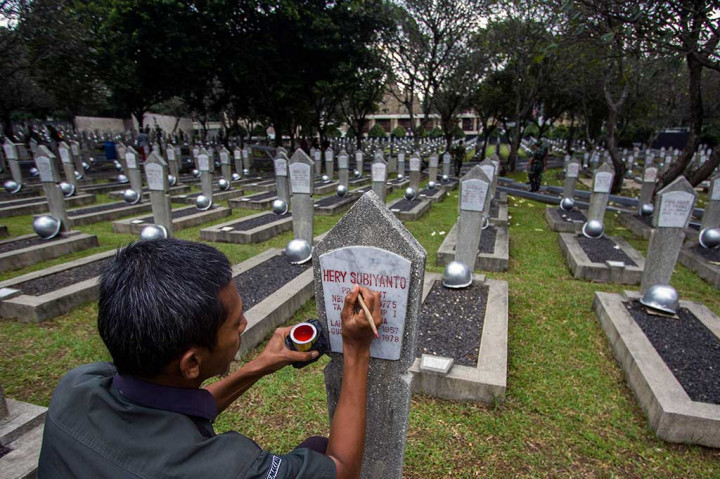 Petugas makam melakukan pengecatan ulang nisan di Taman Makam Pahlawan (TMP) Kalibata, Jakarta, Kamis (9/11/2017). ANTARA/Galih Pradipta