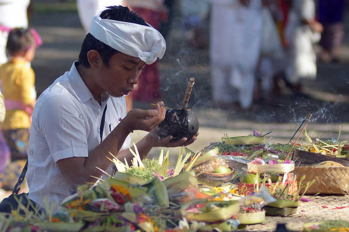 Umat Hindu melakukan persembahyangan di Pura Sakenan. ANTARA/Wira Suryantala