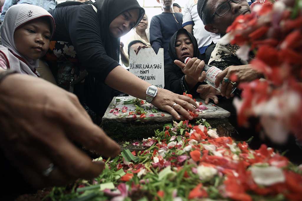 Kerabat menabur bunga di pusaran makam penyanyi Laila Sari di TPU Karet Bivak, Jakarta, Selasa, 21 November 2017. ANTARA/Muhammad Adimaja