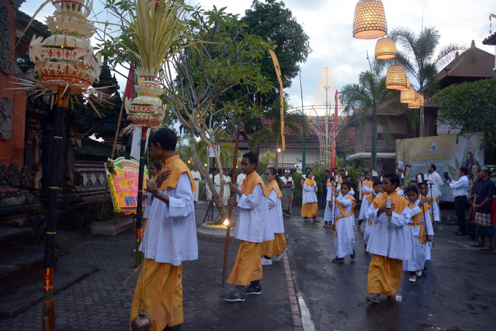 Umat Katolik menyalakan lilin dalam misa Natal di Gereja Katolik Tritunggal Mahakudus Paroki, Desa Tuka, Badung, Bali. Pelaksanaan misa tetap dalam pakaian adat Bali dan beberapa saran upacara seperti halnya umat Hindu di Pulau Dewata. Antara Foto/Wira Suryantala