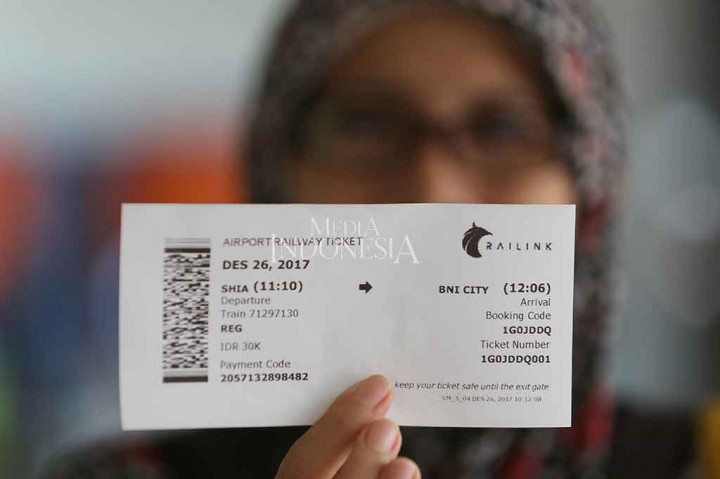 Calon penumpang menunjukkan tiket Kereta Bandara Soekarno-Hatta di Stasiun Bandara Internasional Soekarno Hatta, Tangerang, Banten.
