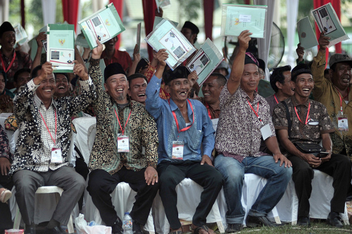 Warga menunjukkan sertifikat tanah usai diterima saat Penyerahan Sertifikat Tanah Untuk Rakyat oleh Presiden yang diwakili Menteri Pendayagunaan Aparatur Negara dan Reformasi Birokrasi Asman Abnur di Sengeti, Muarojambi, Jambi. ANTARA FOTO/Wahdi Septiawan