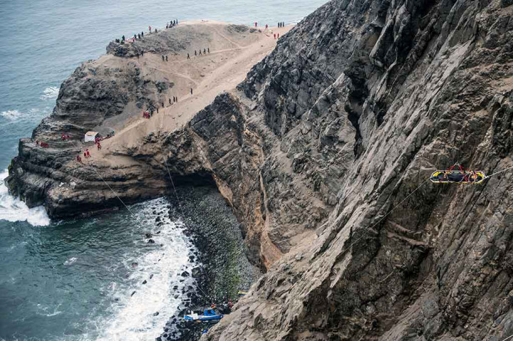 Petugas dengan bantuan tali bersusah payah mengevakuasi korban kecelakaan tersebut dari dasar tebing.