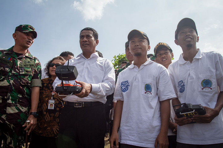 Mentan Amran Sulaiman (kedua kiri) mencoba drone penebar pupuk cair insektisida di sela acara panen raya di Desa Plumbungan, Karangmalang, Sragen. ANTARA FOTO/Mohammad Ayudha