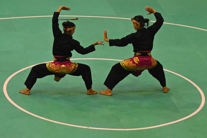 Pasangan pesilat putri Indonesia Ni Made Dwi Yanti dan Sang Ayu Ketut Sidan Wilantari menampilkan jurus dalam final nomor artistik ganda putri cabang pencak silat 18th Asian Games Invitation Tournament di Padepokan Pencak Silat TMII, Jakarta.
