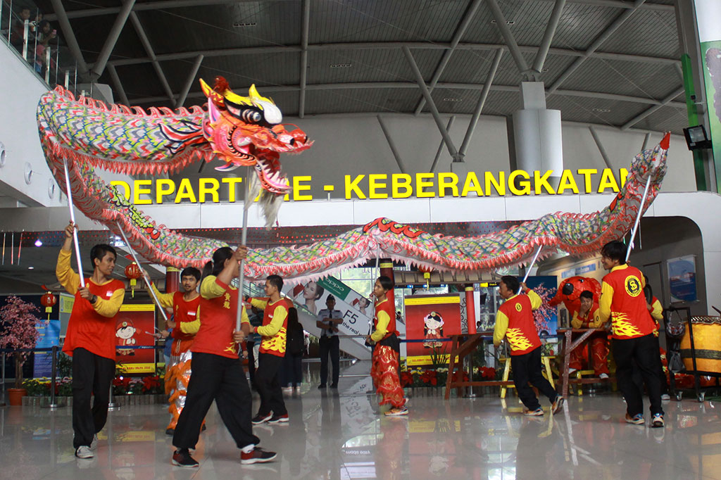 Penari Liang Liong mempertontonkan atraksi di hadapan calon penumpang di Terminal 2 Bandara Internasional Juanda, Surabaya, Jawa Timur, Jumat. ANTARA/Umarul Faruq