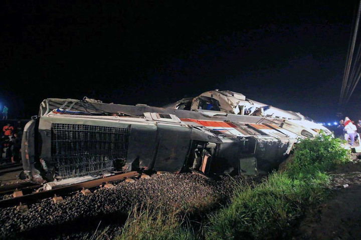 Petugas berusaha mengevakuasi Kereta Api Sancaka jurusan Yogyakarta-Surabaya yang terguling usai terlibat kecelakaan dengan truk pengangkut bantalan rel di perlintasan KM 215 Walikukun, Ngawi, Jawa Timur, Jumat, 6 April 2018 malam. 