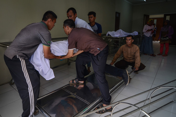 Keluarga memindahkan jenazah korban meninggal akibat keracunan minuman keras (miras) oplosan ke dalam mobil ambulans di Rumah Sakit Umum Daerah (RSUD) Cicalengka, Kabupaten Bandung, Jawa Barat.