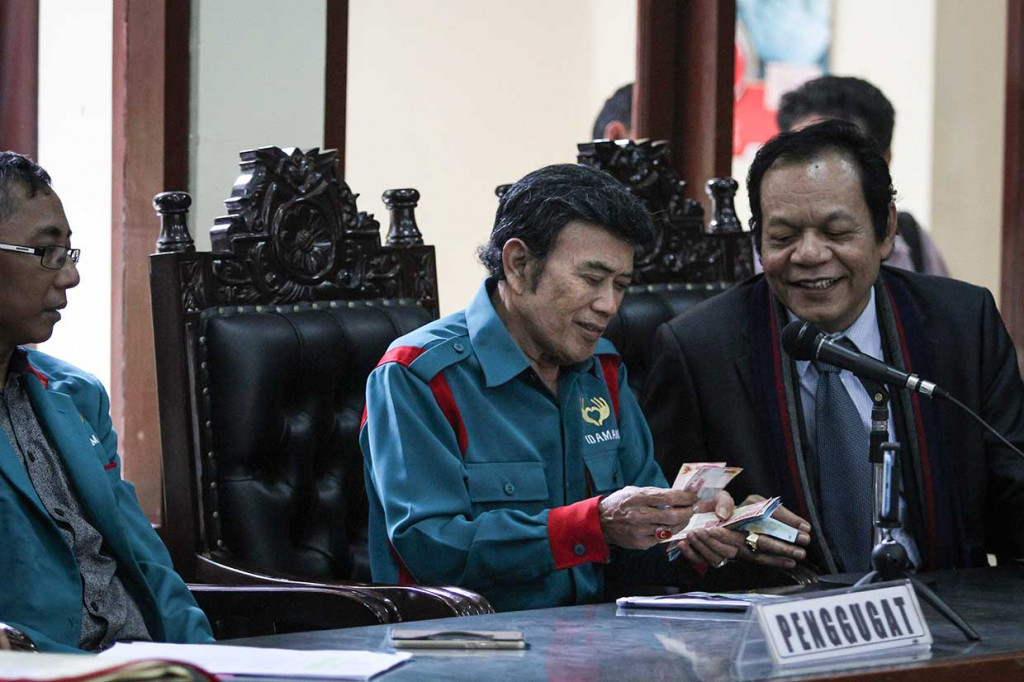 Ketua Umum Partai Islam Damai Aman (Idaman) Rhoma Irama (tengah) mengumpulkan uang untuk membayar biaya perkara saat sidang pembacaan putusan di Pengadilan Tata Usaha Negara (PTUN), Jakarta, Selasa, 10 April 2018.