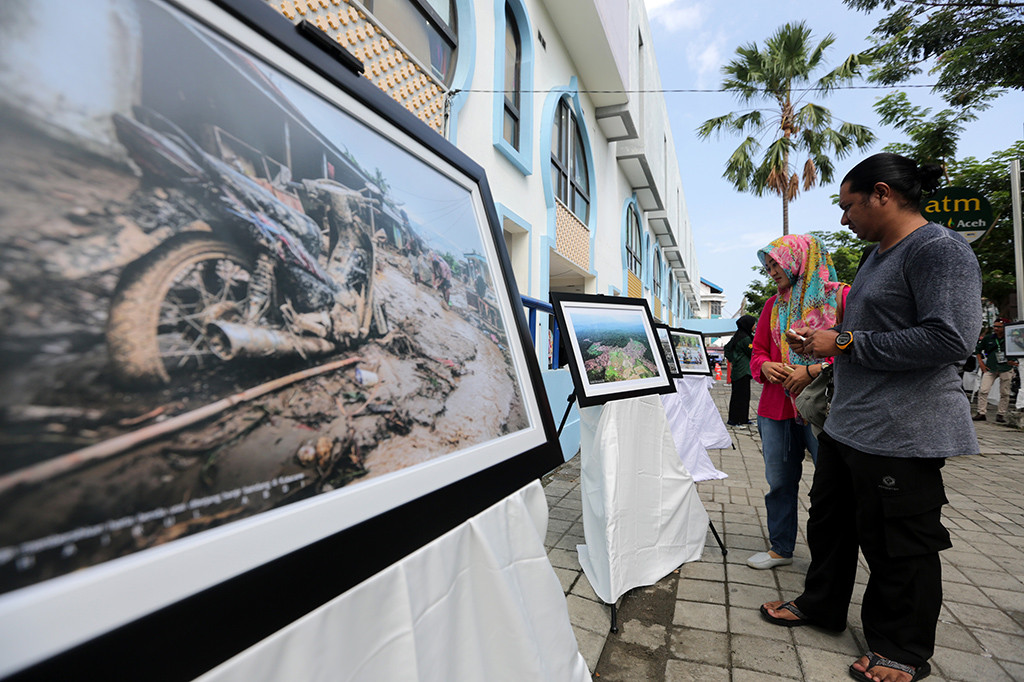 Warga melihat pameran foto Ancaman dan Kerusakan Hutan karya jurnalis dan aktivis lingkungan, di Banda Aceh, Aceh. Pameran yang memamerkan 40 foto merupakan rangkaian acara menyambut dan memperingati Hari Bumi 22 April 2018. ANTARA/Irwansyah Putra