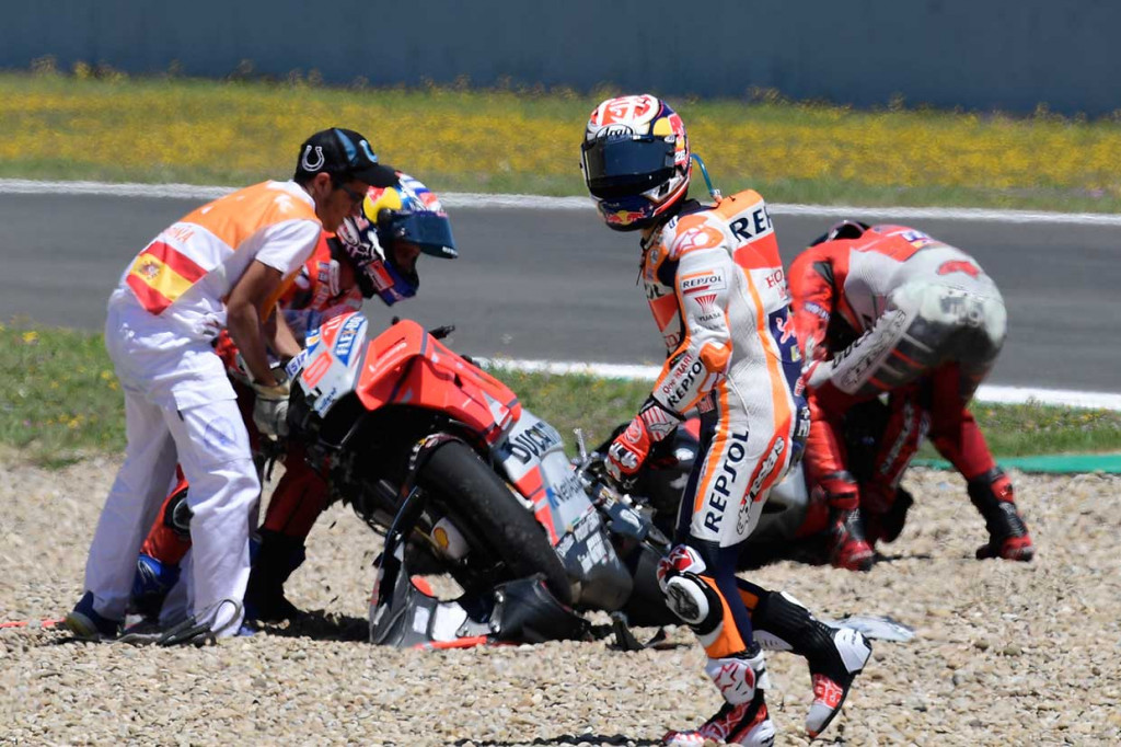 Pedrosa berjalan meninggalkan lintasan usai terlibat tabrakan dengan Dovizioso dan Lorenzo, yang membuat ketiganya tidak bisa melanjutkan balapan.
