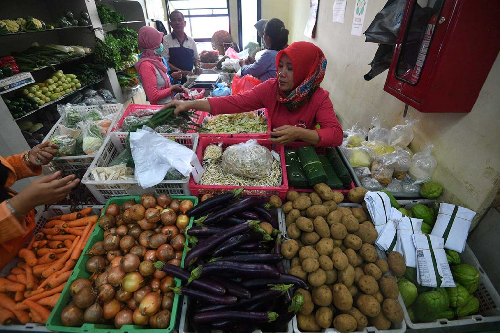 Pedagang sayur melayani calon pembeli di Toko Tani Indonesia Centre, Pasar Minggu, Jakarta Selatan.