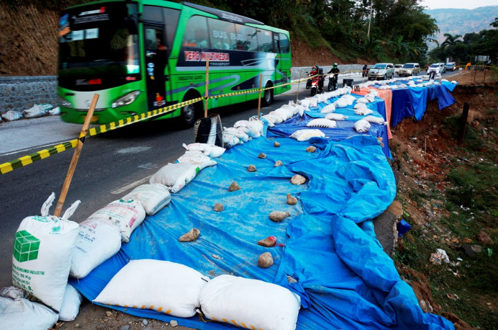 Sejumlah kendaraan melintas di jalan raya Ponorogo-Trenggalek Km 32 ruas Pangkal, Ponorogo, Jawa Timur, yang rusak akibat longsor, Sabtu (16/6/2018). Kepadatan arus balik terjadi sejak H+1 di jalan yang relatif sempit dan sebagiannya ruas rusak parah terdampak longsor/tanah ambles. 